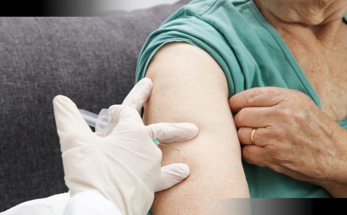 Senior woman receiving vaccine. Medical worker vaccinating an elderly patient against flu, influenza, pneumonia or coronavirus.