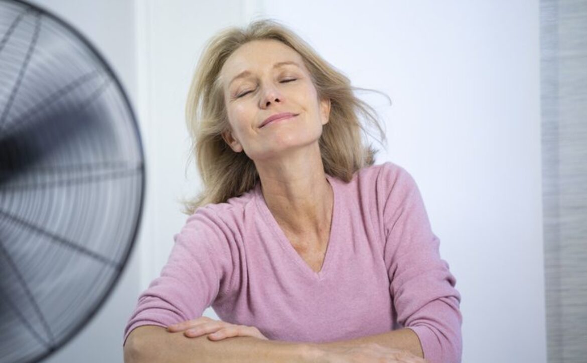 A menopausal woman having a hot flush.